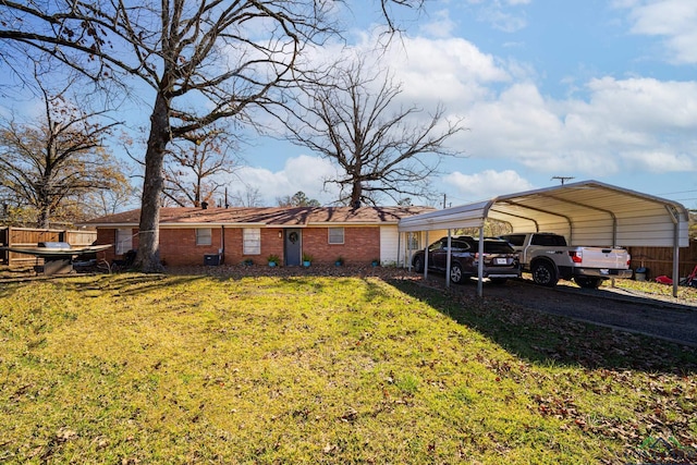 view of front facade with a front yard and a carport