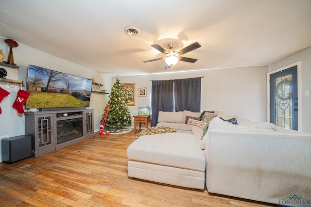 living room with ceiling fan and hardwood / wood-style flooring