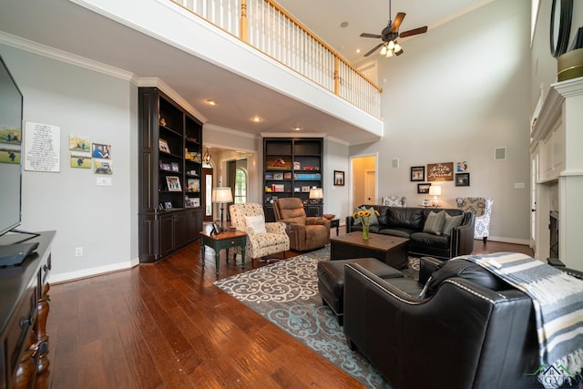 335 Winding Way, Hallsville, TX 75650 - living room with dark wood-type flooring, ceiling fan, ornamental molding, baseboards, and a high ceiling
