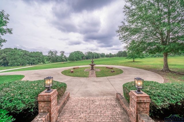 335 Winding Way, Hallsville, TX 75650 - view of community with a yard and curved driveway