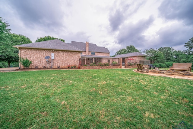 335 Winding Way, Hallsville, TX 75650 - back of house with brick siding and a patio area