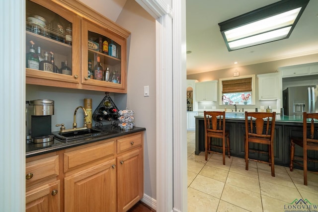 335 Winding Way, Hallsville, TX 75650 - bar area with a sink, crown molding, stainless steel fridge, and light tile patterned floors