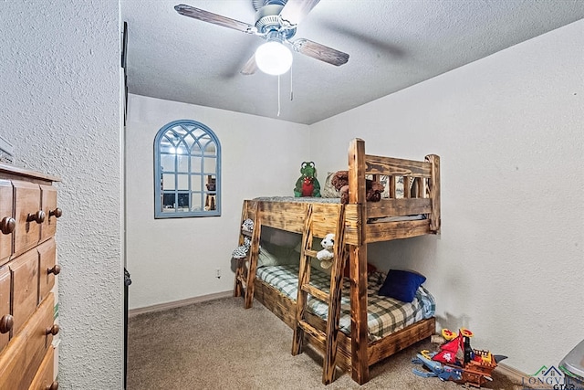 bedroom with carpet flooring, a textured ceiling, and ceiling fan