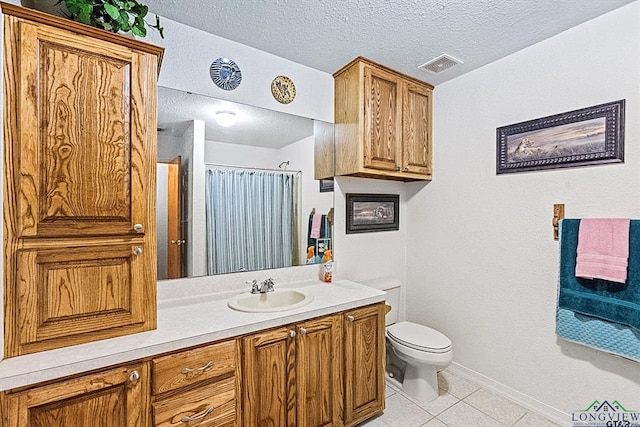 bathroom with a shower with curtain, vanity, a textured ceiling, tile patterned flooring, and toilet