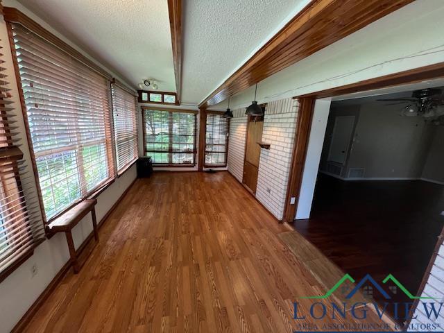 interior space featuring hardwood / wood-style floors and a textured ceiling