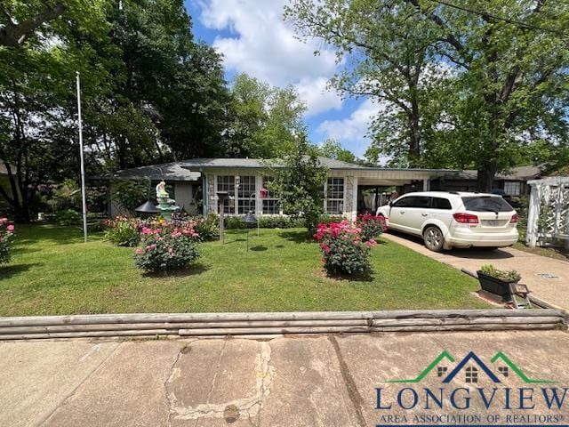 single story home featuring a front lawn and a carport