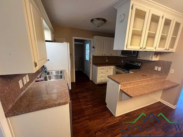 kitchen featuring sink, dark hardwood / wood-style floors, white fridge, electric stove, and white cabinets