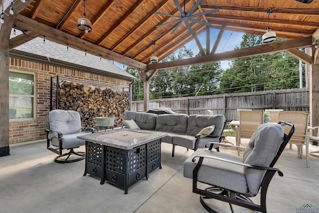 view of patio / terrace with a gazebo, ceiling fan, and an outdoor living space with a fire pit