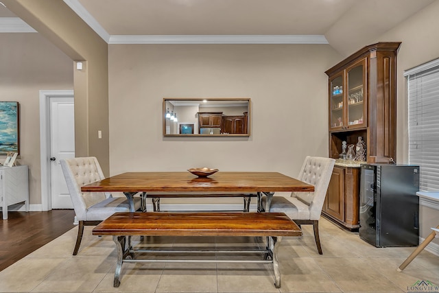 dining area with crown molding and light tile patterned floors