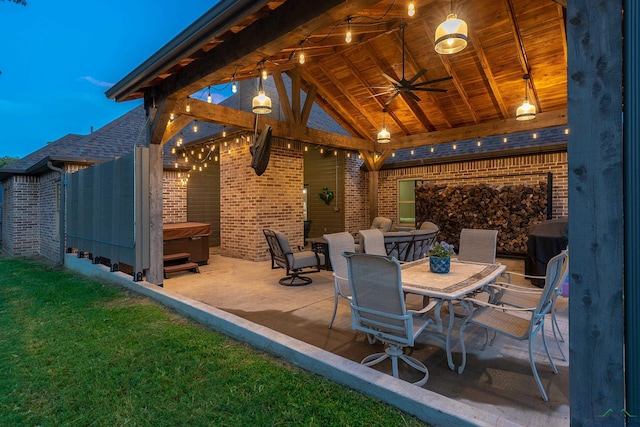 view of patio / terrace with a gazebo, ceiling fan, and a hot tub