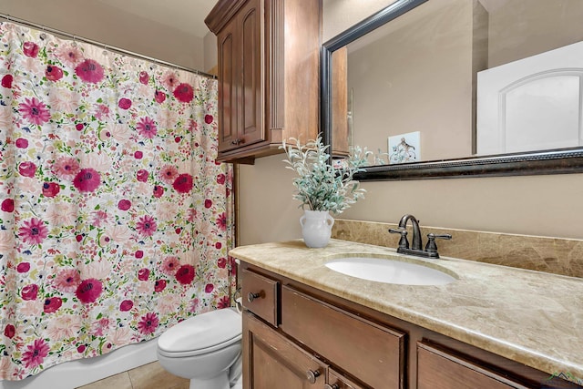 bathroom with tile patterned floors, vanity, and toilet