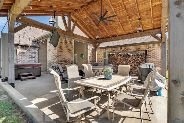 view of patio with a gazebo, ceiling fan, and a hot tub