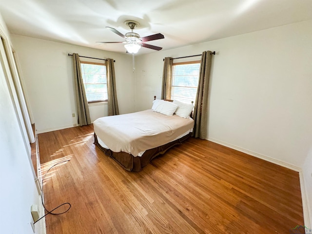 bedroom with ceiling fan and light hardwood / wood-style floors