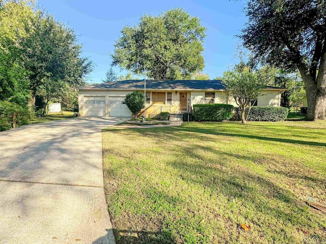 ranch-style home with a garage and a front yard