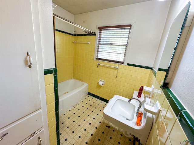 215 Oxford Ln, Longview, TX 75601 - full bath featuring tile walls, wainscoting, and shower / bathtub combination