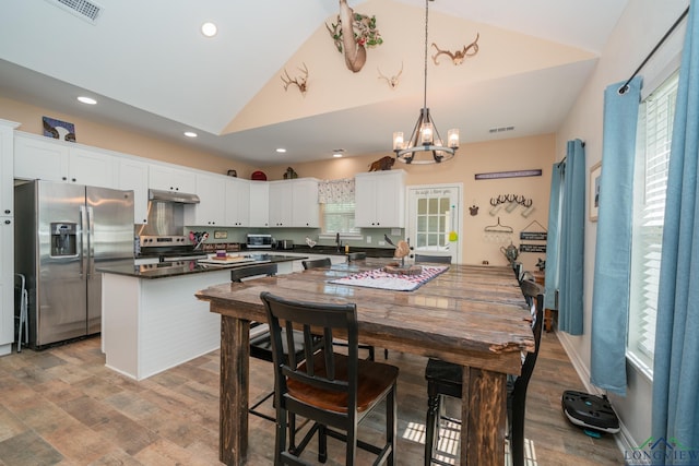 dining room featuring visible vents, wood finished floors, and recessed lighting