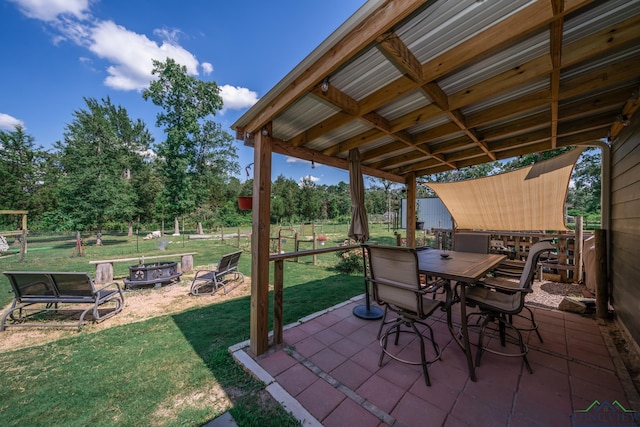 view of patio / terrace featuring an outdoor fire pit, fence, and outdoor dining area