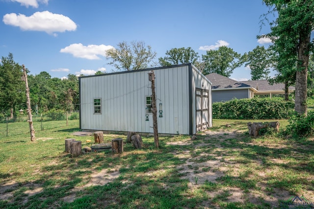 view of outbuilding featuring an outdoor structure and fence