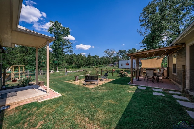 view of yard with a garden, a patio, and fence