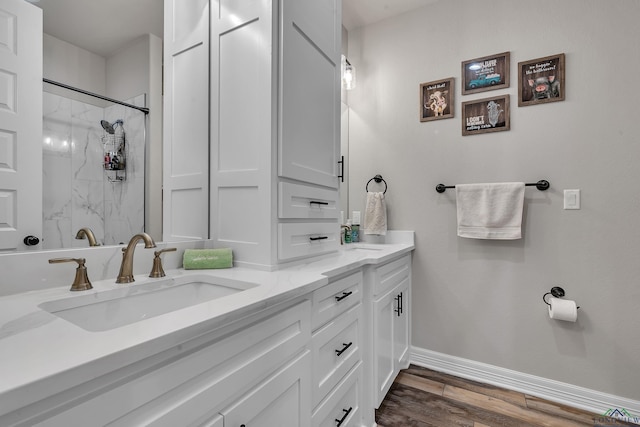 bathroom featuring a shower, hardwood / wood-style floors, and vanity