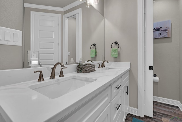 bathroom with hardwood / wood-style floors, vanity, and ornamental molding