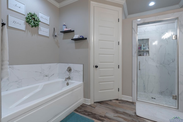 bathroom featuring wood-type flooring, shower with separate bathtub, and ornamental molding