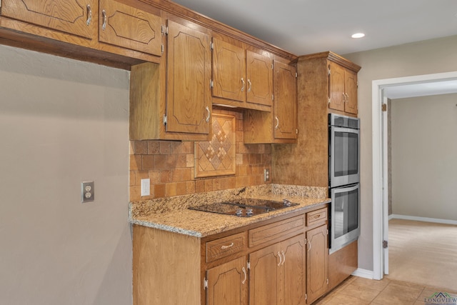 kitchen featuring recessed lighting, stainless steel double oven, black electric stovetop, decorative backsplash, and baseboards