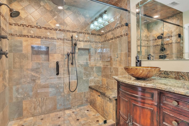 full bathroom featuring visible vents, vanity, and a stall shower