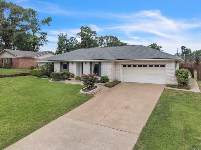 ranch-style house with a front lawn, concrete driveway, brick siding, and a garage