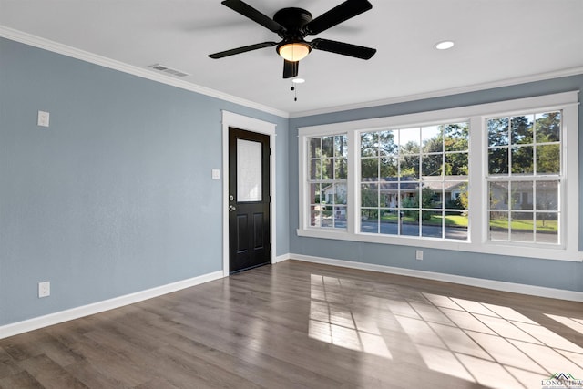 spare room with hardwood / wood-style flooring, ceiling fan, and crown molding