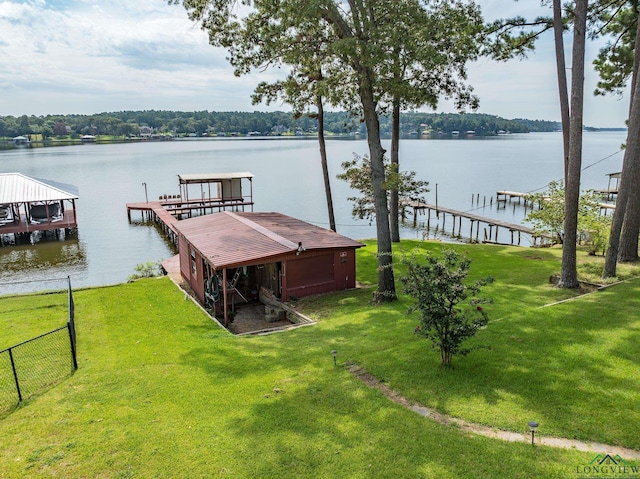 view of dock featuring a lawn and a water view