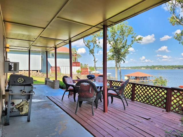 deck with a water view and grilling area