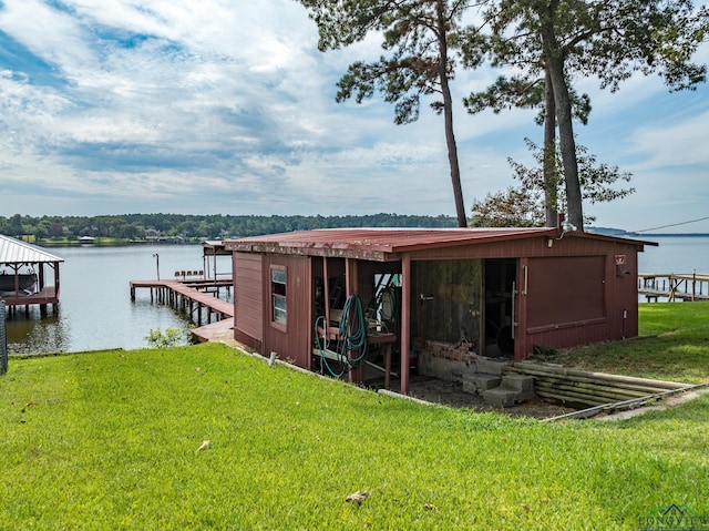 view of dock with a water view and a yard