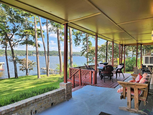 unfurnished sunroom featuring a water view