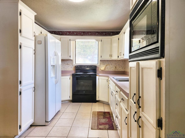 kitchen with black range with electric stovetop, built in microwave, white fridge with ice dispenser, and a textured ceiling