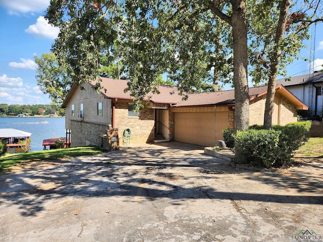 view of front facade with a garage and a water view