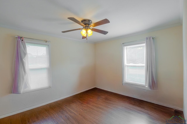 spare room with crown molding, dark wood-style floors, and a wealth of natural light