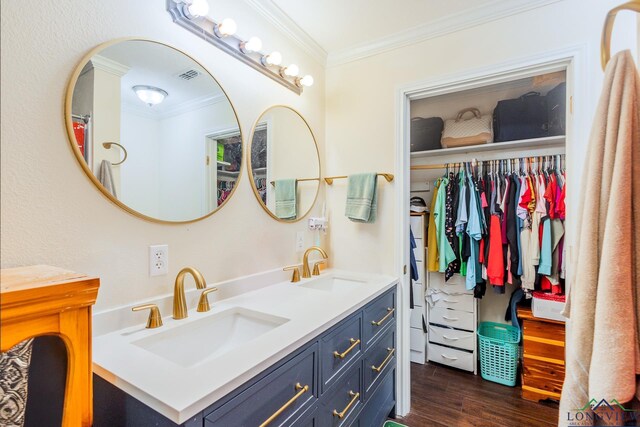 500 Jasper Dr, Marshall, TX 75672 - full bathroom featuring double vanity, a sink, wood finished floors, and ornamental molding