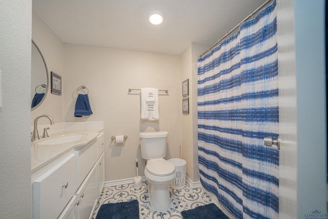 bathroom with tile patterned floors, walk in shower, vanity, and toilet