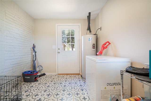 laundry area featuring brick wall and water heater