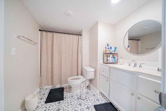 bathroom with toilet, vanity, and tile patterned floors