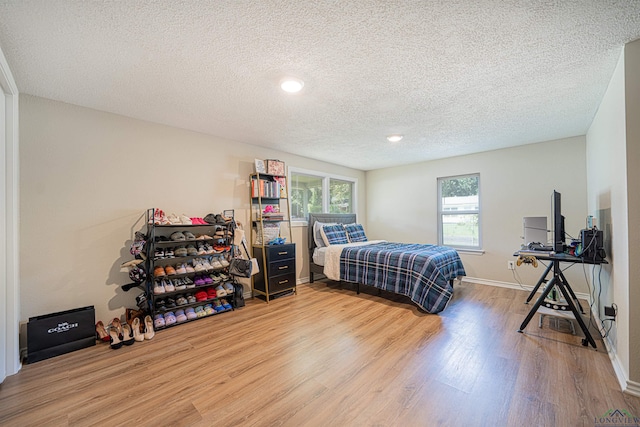 bedroom featuring wood-type flooring and a textured ceiling