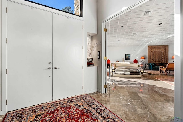 foyer entrance with a towering ceiling