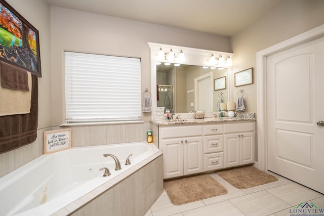 bathroom with a jetted tub, a shower stall, and vanity