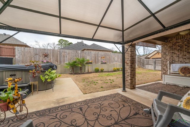 view of patio featuring a fenced backyard and a gazebo