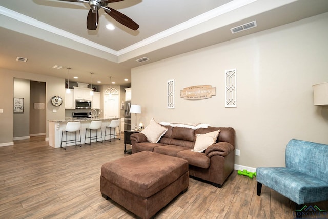 living room featuring light wood-style floors and visible vents