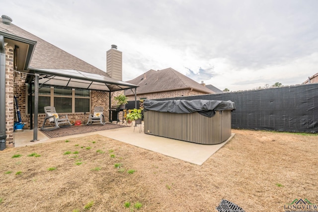 view of yard featuring a gazebo, a patio area, fence, and a hot tub