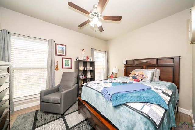 bedroom with wood finished floors, a ceiling fan, and baseboards