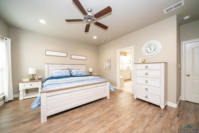 bedroom with light wood finished floors, baseboards, and visible vents