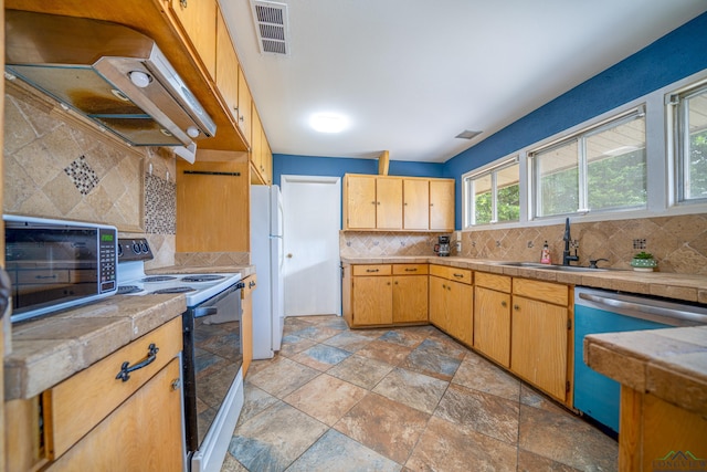 kitchen featuring decorative backsplash, sink, extractor fan, and white appliances